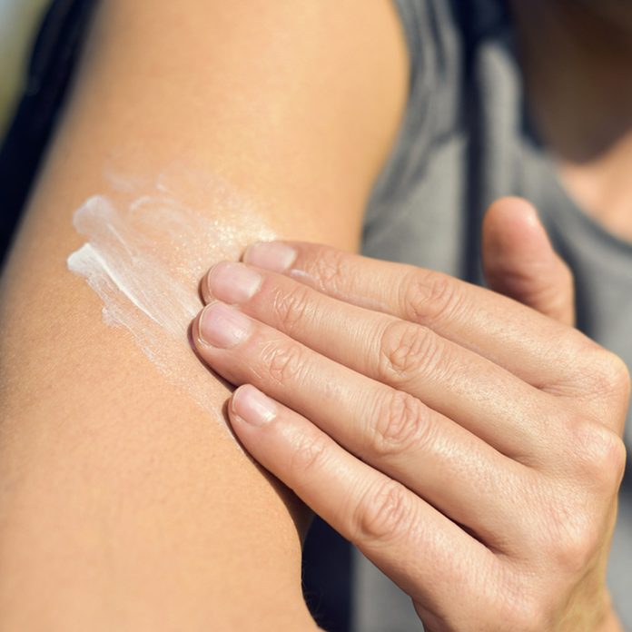putting on sunscreen