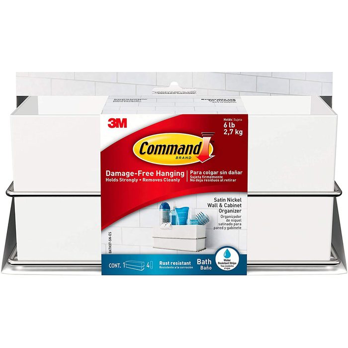 A wall organizer holds bath items securely. It is packaged with branding, displaying its features and benefits prominently. It's designed for damage-free hanging in bathrooms.