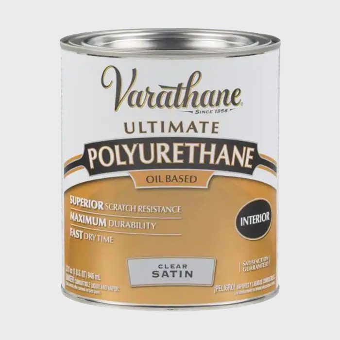 A can of Varathane polyurethane rests upright. It's labeled as oil-based, for interior use, featuring clear satin finish with claims of scratch resistance and durability.
