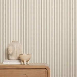 A textured vase and bowl rest on a wooden surface, against a light striped wall, creating a serene, decorative setting.