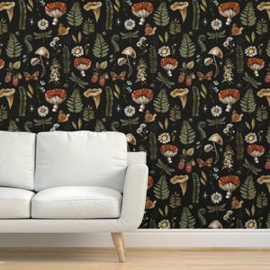 A light-colored sofa sits against a dark, nature-themed wallpaper featuring various plants, mushrooms, and insects, creating a cozy, vibrant atmosphere.