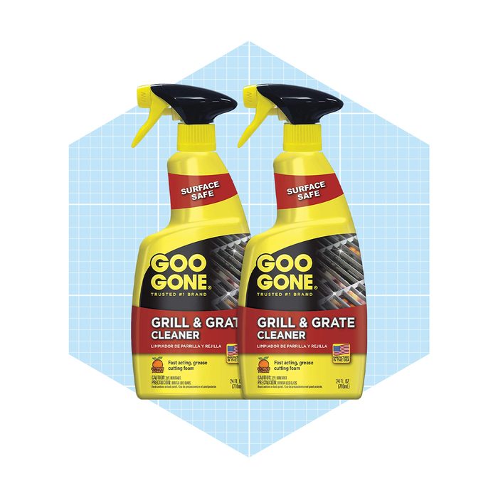 Two bottles of Goo Gone Grill & Grate Cleaner are poised side by side. They feature spray tops, on a light blue geometric background.