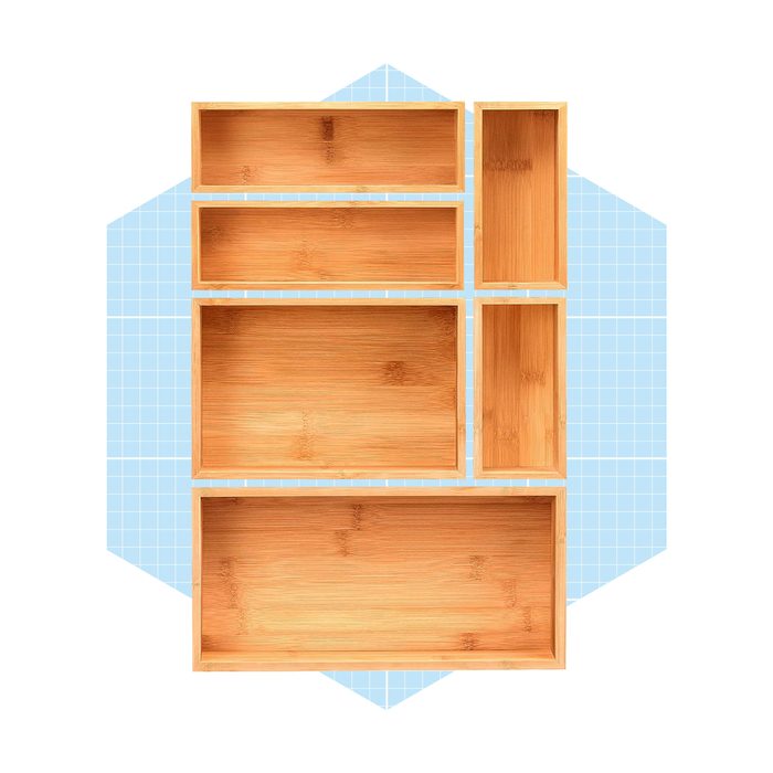 Six bamboo storage boxes are arranged on a light blue grid background, showcasing their varying sizes and rectangular shapes for organizational purposes.