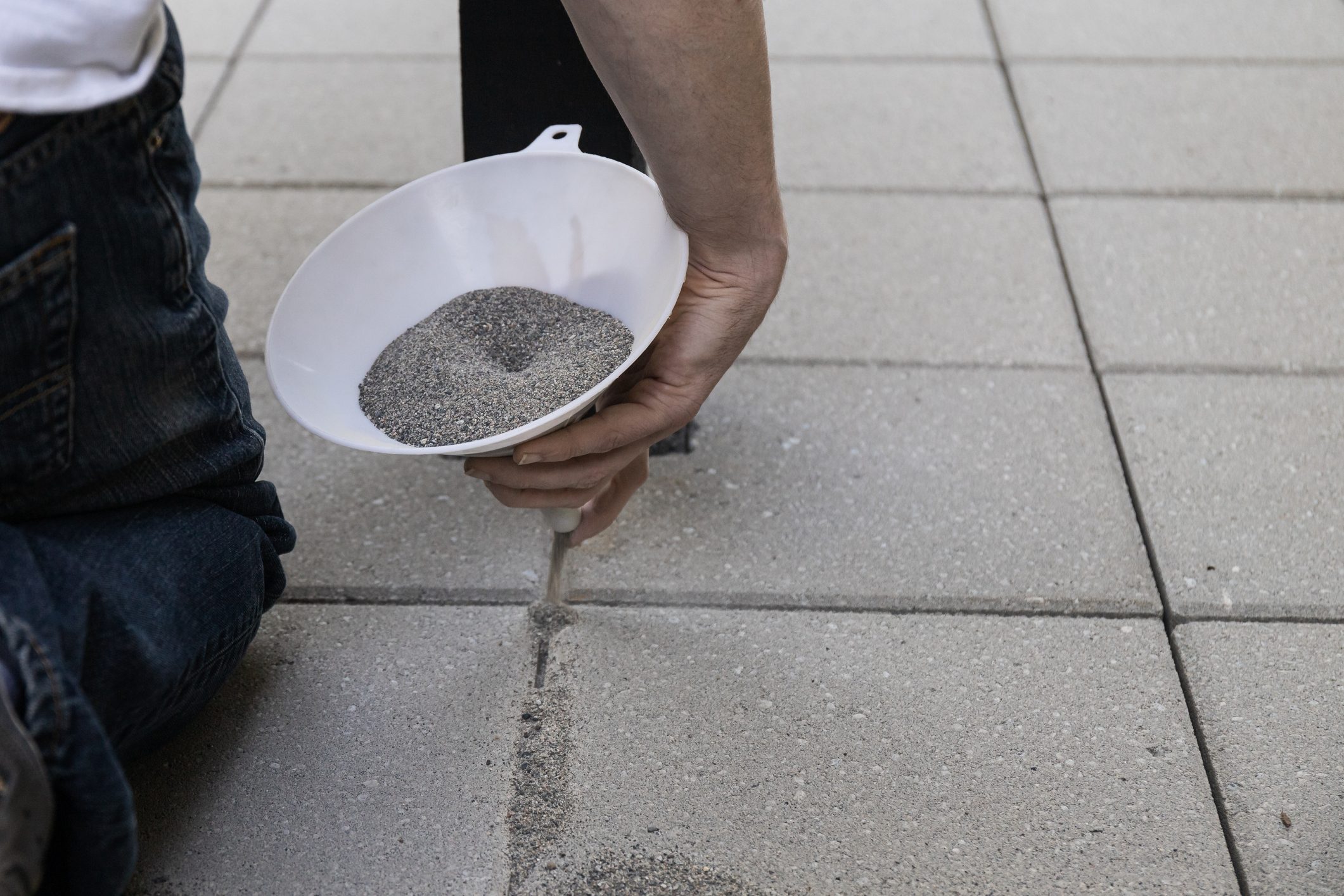 Pouring Jointing Sand in Paver Patio Installation